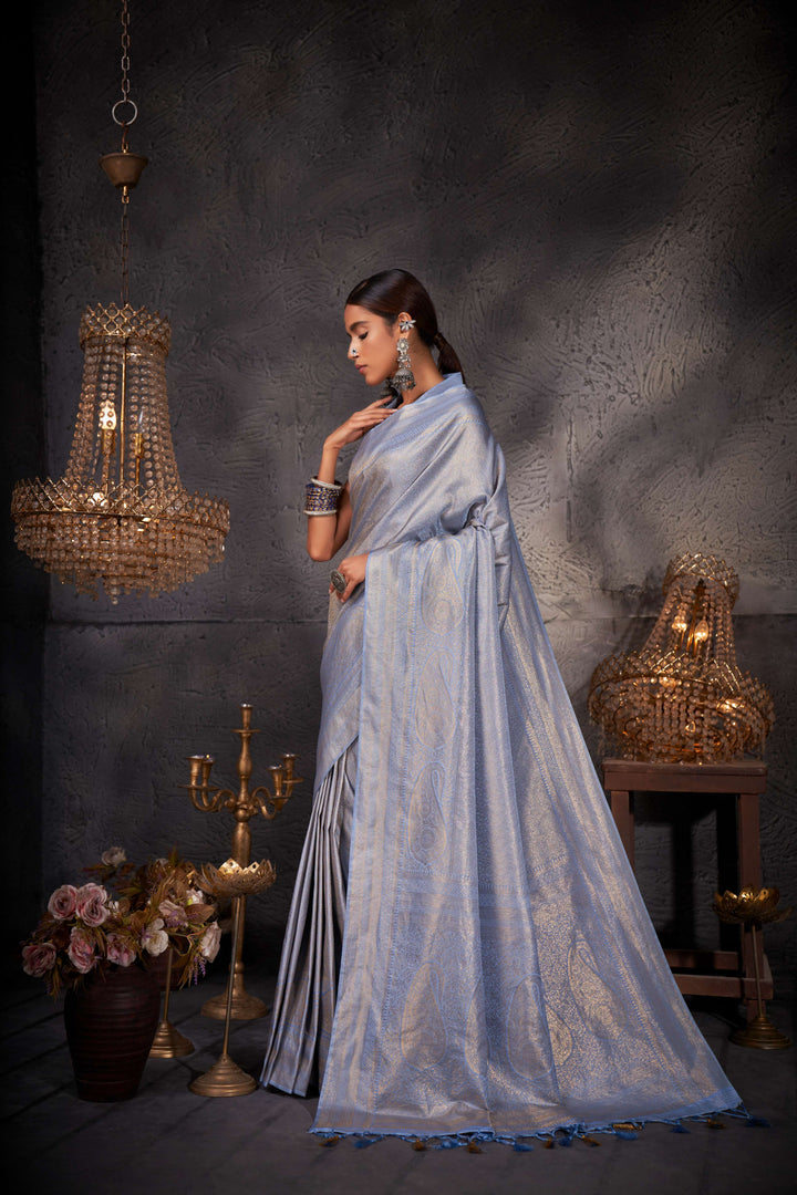 Columbia blue unstitched blouse piece placed beside the saree