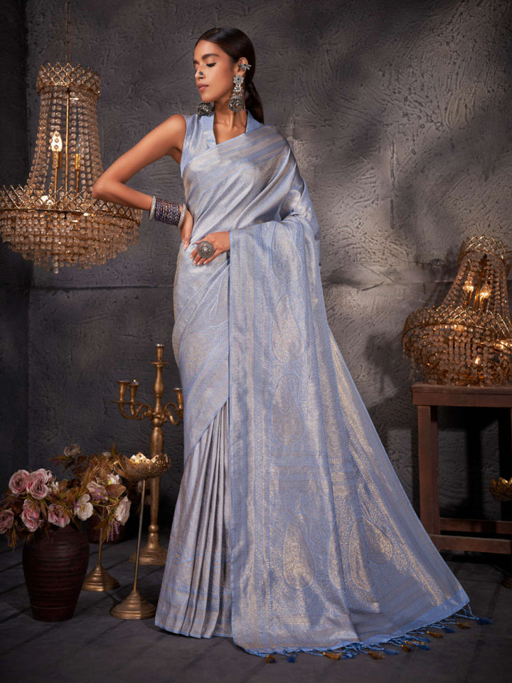 Model wearing columbia blue Kanjeevaram saree with detailed zari pallu