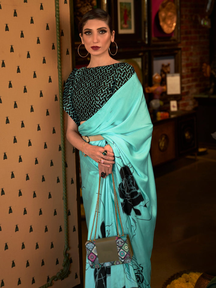 Elegant cyan blue and smoky black Bollywood-style crepe saree adorned with stylish digital prints, suitable for festive celebrations.
