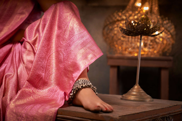Close-up of the saree's intricate gold zari work on the pallu and border, showcasing traditional craftsmanship.