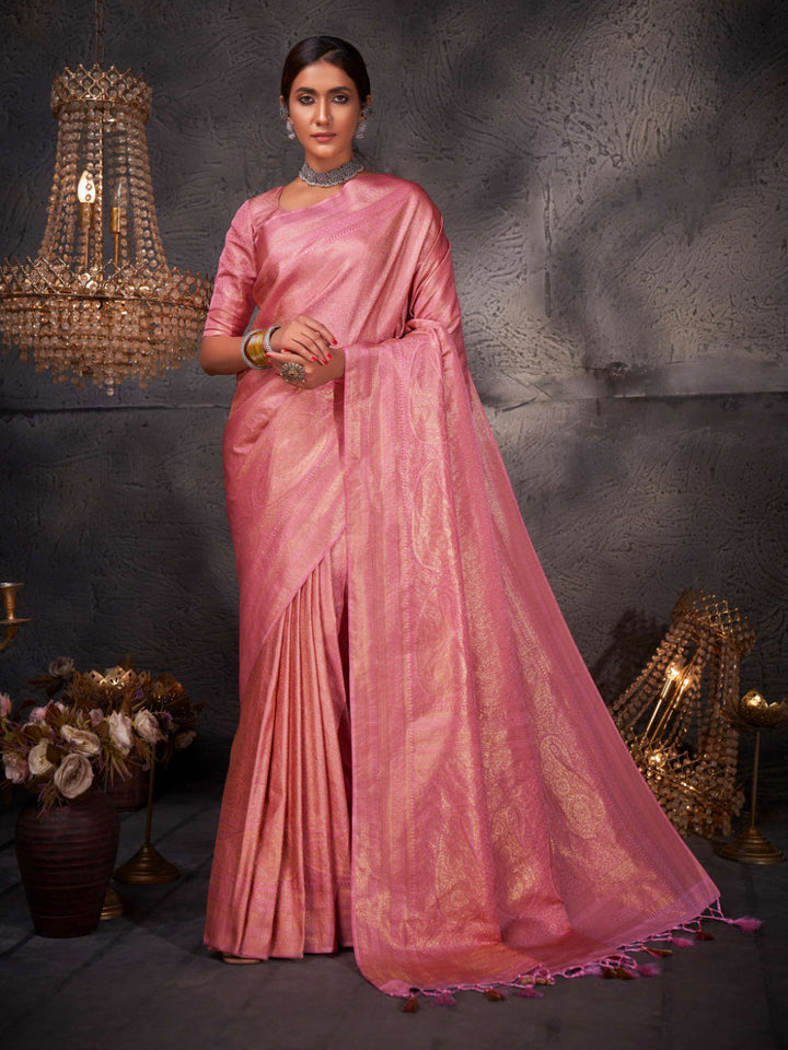 Front full-length view of model draped in a flamingo pink Kanjeevaram saree with rich gold zari motifs.