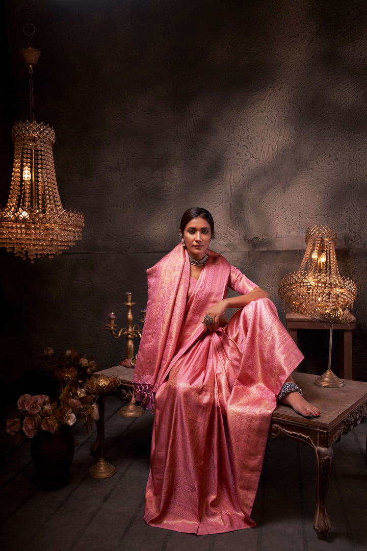 Model twirling in the saree, capturing the elegant flow and vibrant flamingo pink hue in motion.