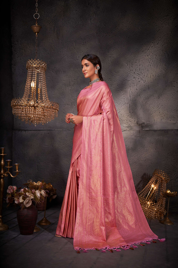 Side profile of the model pairing the saree with traditional gold jewelry, enhancing the regal appeal.