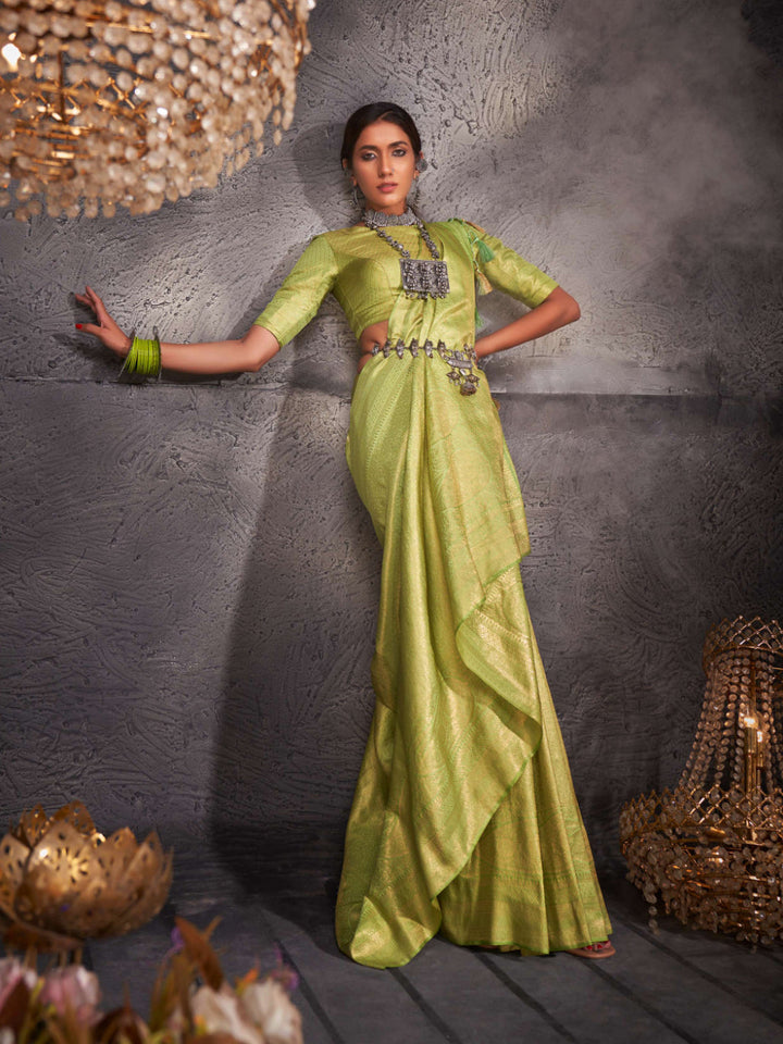 Full view of model wearing jade green Kanjeevaram saree with woven gold zari detailing.