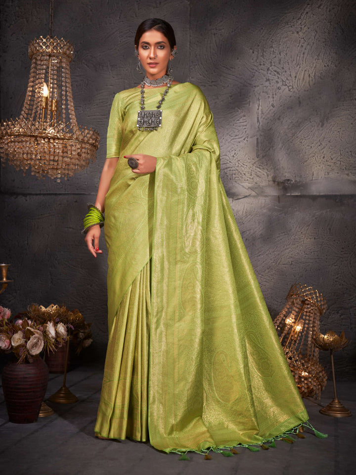Flat lay of the saree and matching blouse piece, showcasing the rich green hue.