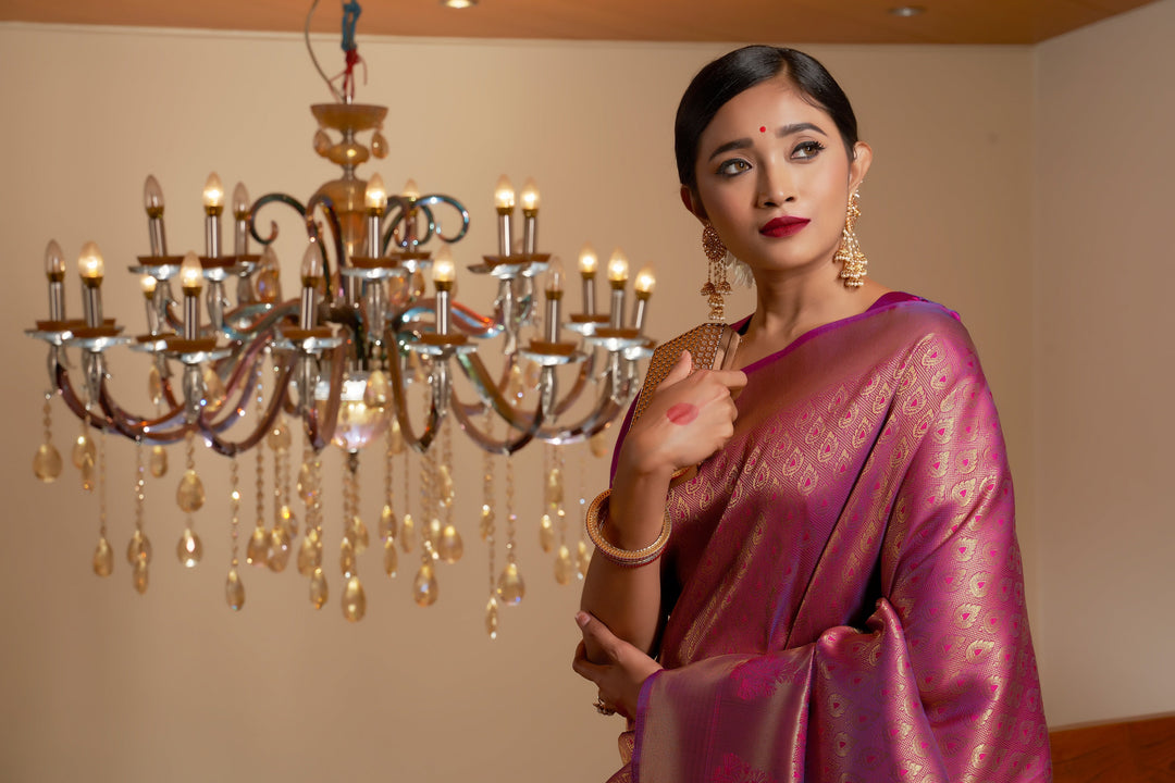 Close-up of tiny leaf buttas and large floral zari motifs on the border.
