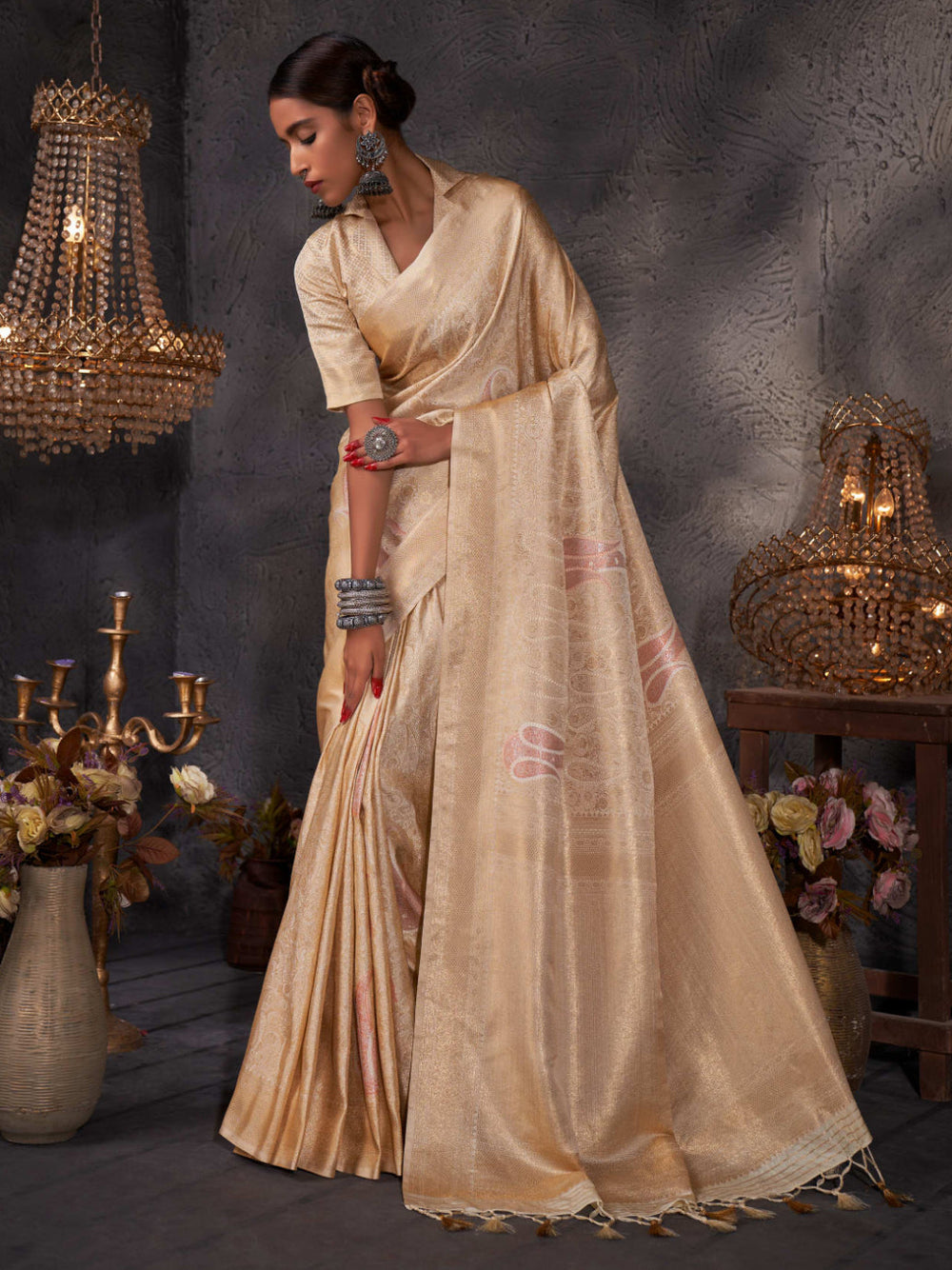 Over-the-shoulder view emphasizing the zari-rich pallu and fluid drape.