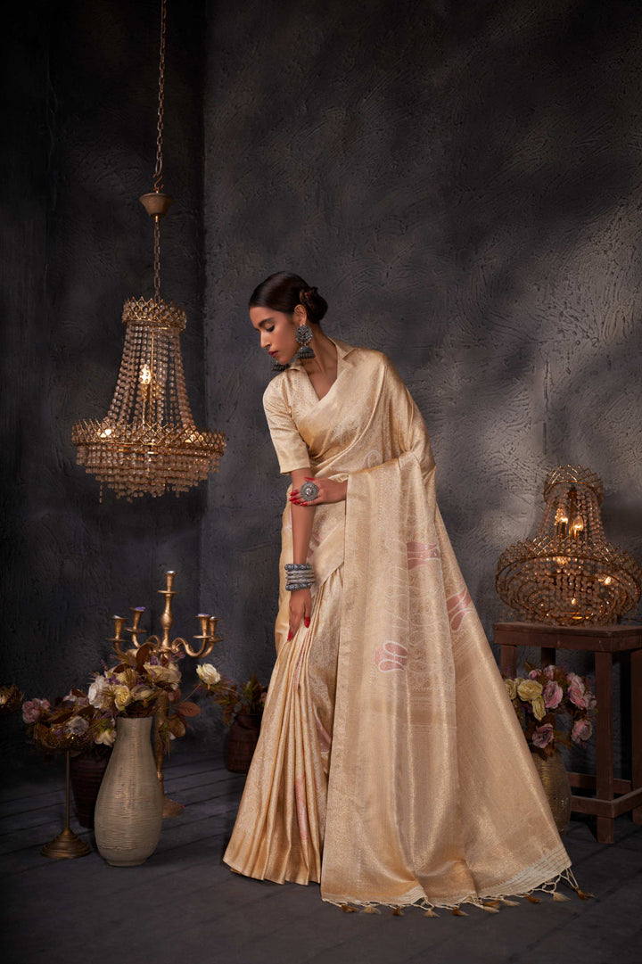 Flat lay of the saree and matching blouse piece showing cohesive off-white color palette.