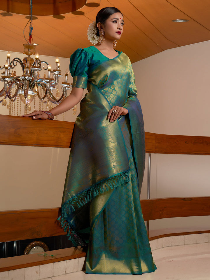 Model wearing Pine Green Golden Zari Kanjeevaram Silk Saree, showcasing full drape with rich zari work.