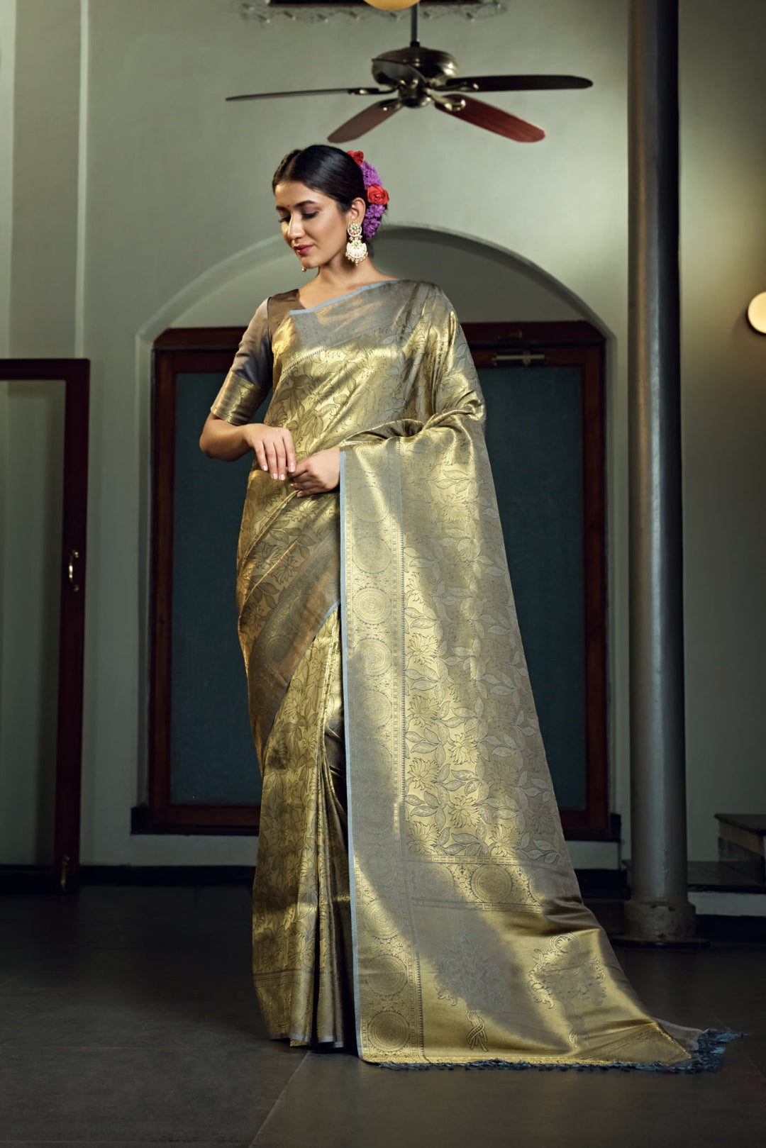 Flat-lay image showing the saree with the unstitched blouse piece and border intricacy.