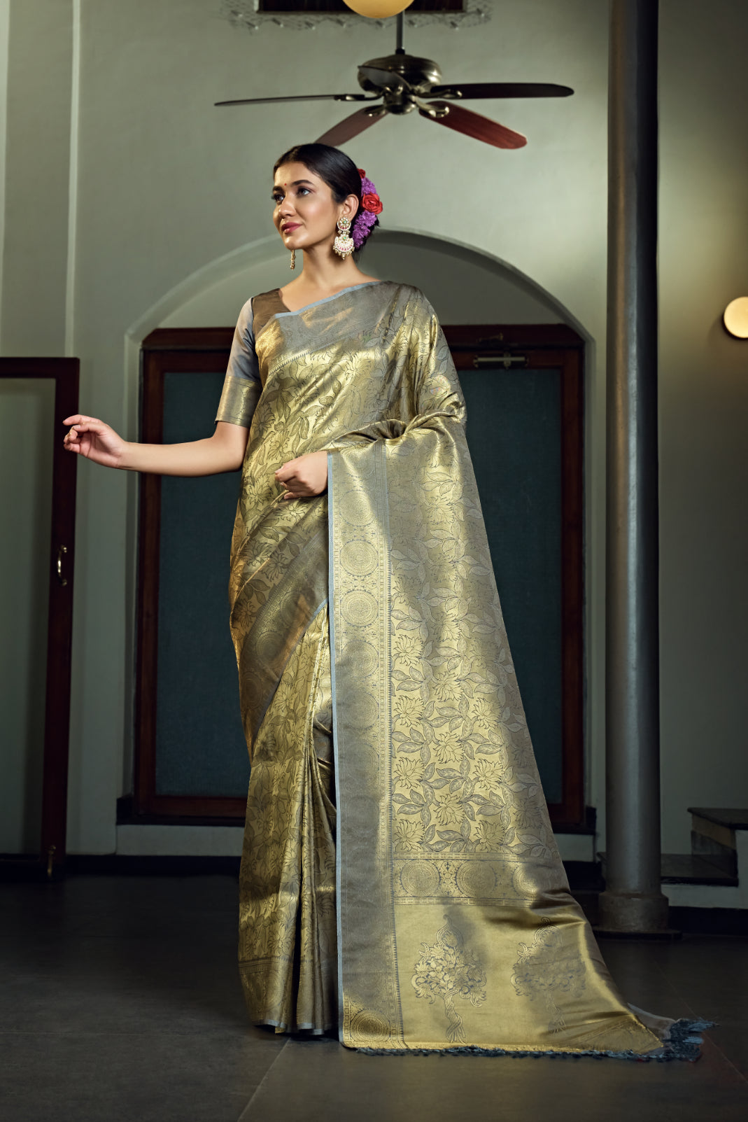 The saree highlighting the pleats and pallu drape with matching blouse.