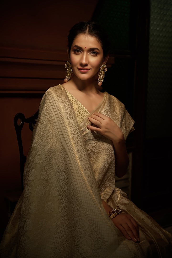 Side pose of model wearing the saree, showcasing the rich zari border and elegant silhouette for festive and bridal wear.