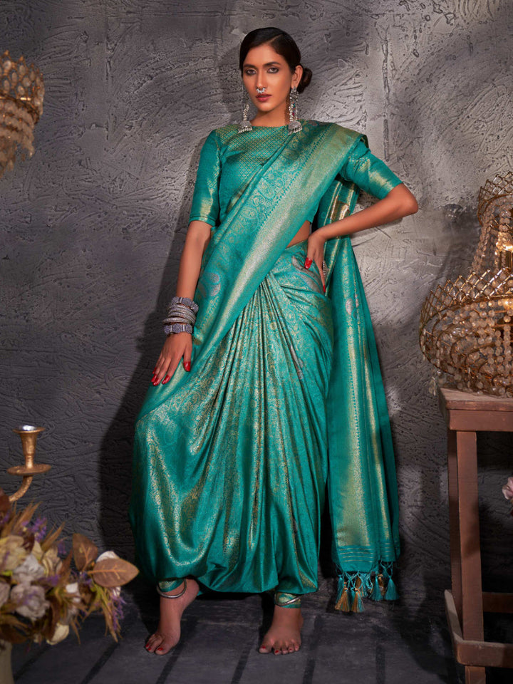 Model draped in robin egg blue Kanjeevaram saree with shimmering gold, copper, and silver zari.