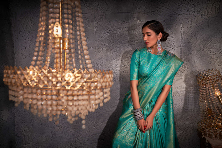 Flat lay of saree with matching blouse piece and accessory suggestions.