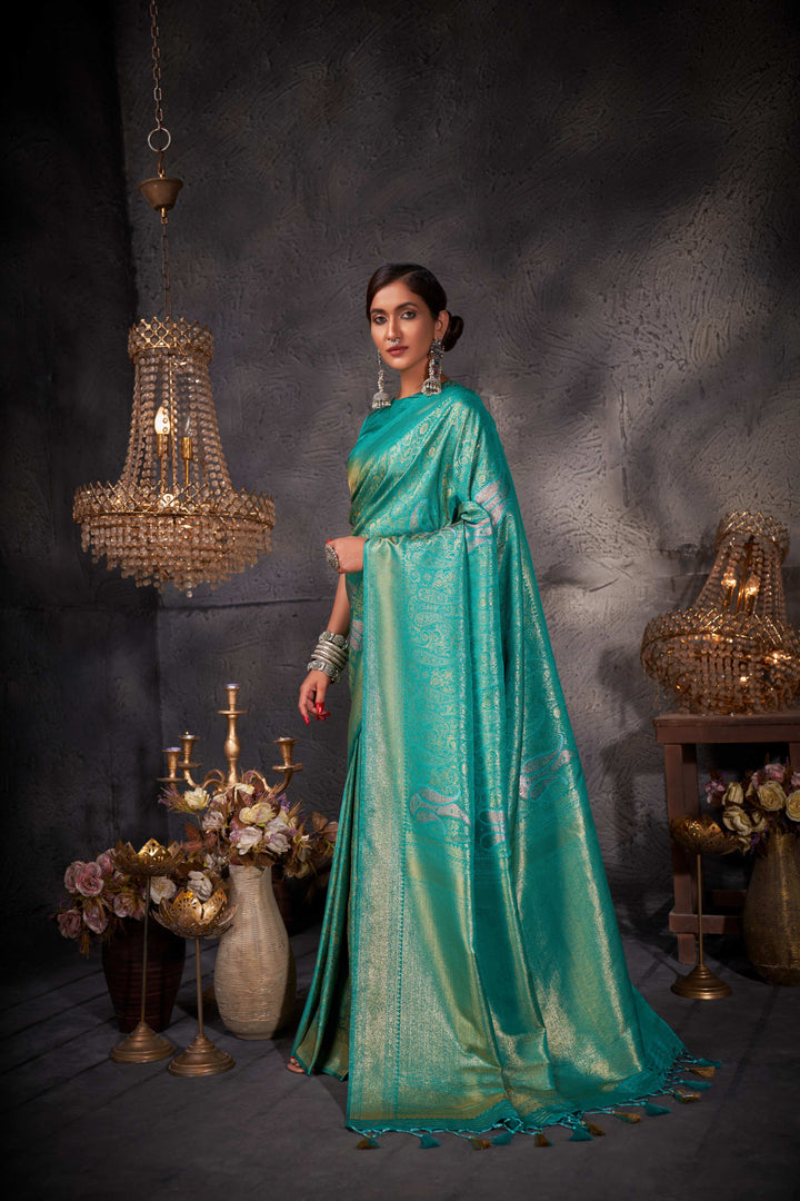 Flat lay of saree with matching blouse piece and accessory suggestions.