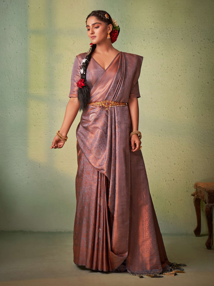 Model styled in traditional jewelry wearing grey silk saree.