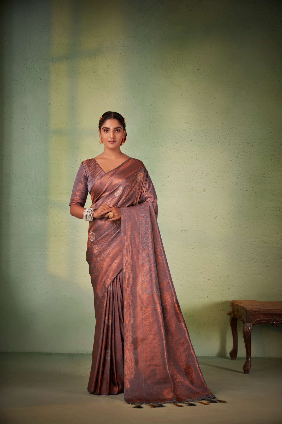 Elegant handwoven Kanjeevaram silk saree with matching blouse.