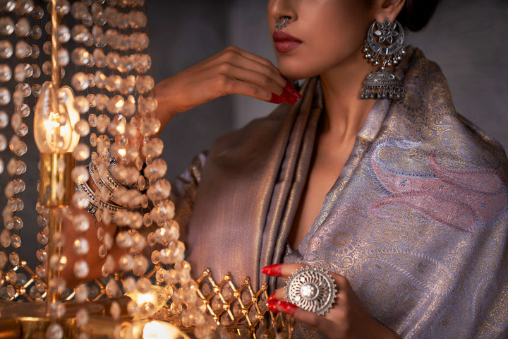 Detail view of the pallu’s edge, highlighting the fusion of warm and cool metallic zari tones.