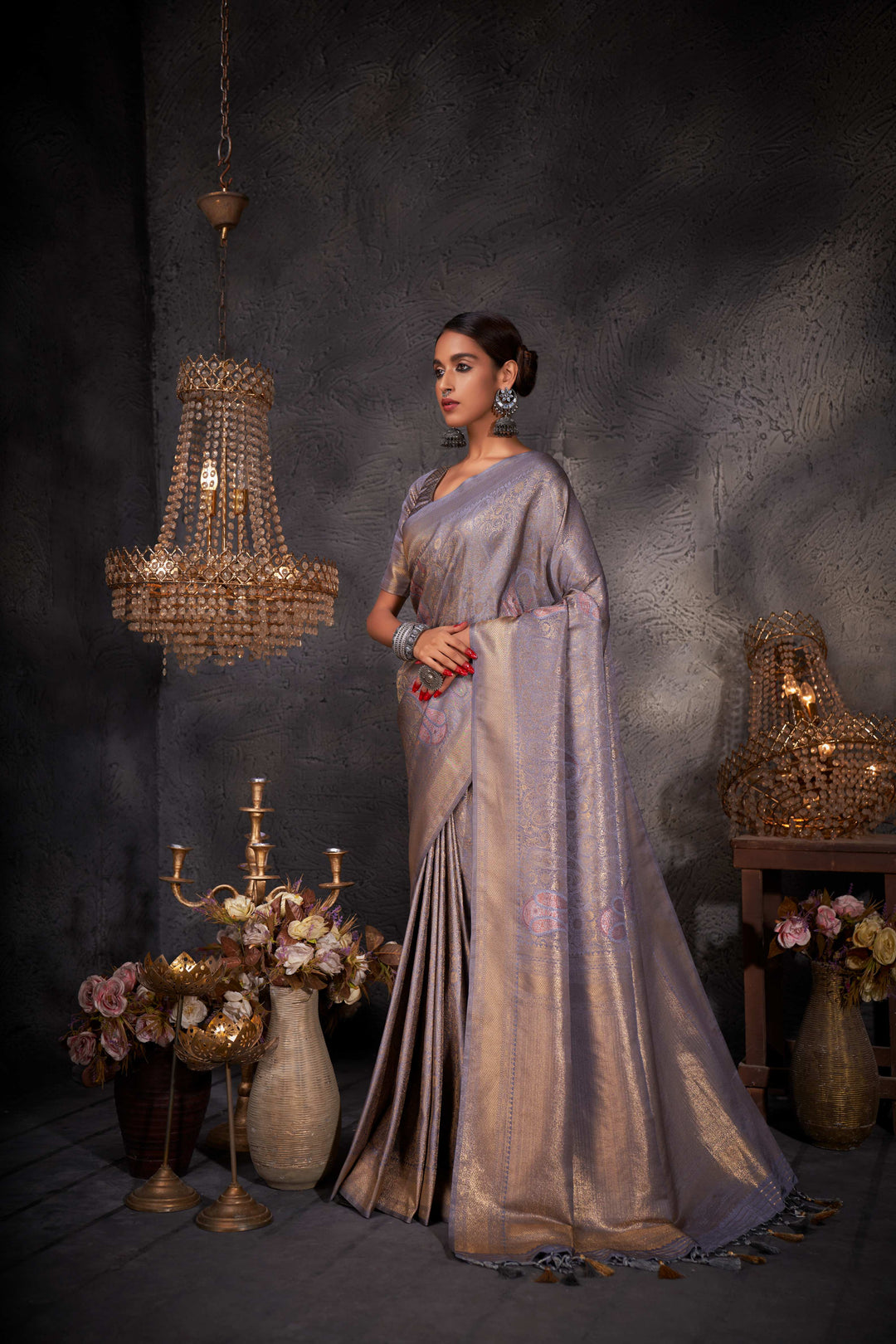 Side profile of the model highlighting the graceful drape and sheen of the saree.