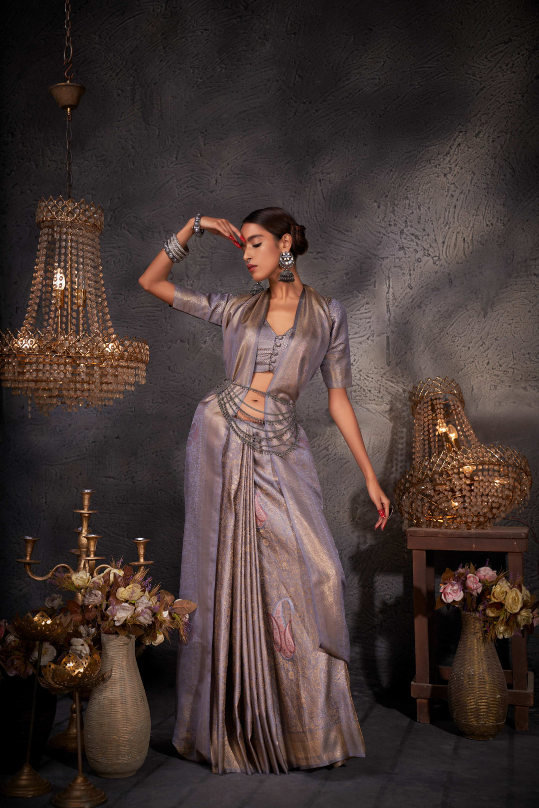 Flat lay of the saree and blouse piece emphasizing the uniform grey tone and intricate zari borders.