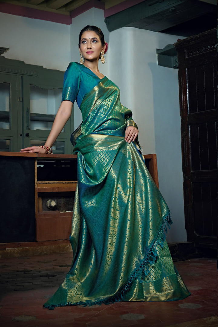 Side view of the saree worn with pleats and jewelry, focusing on the texture and fall.