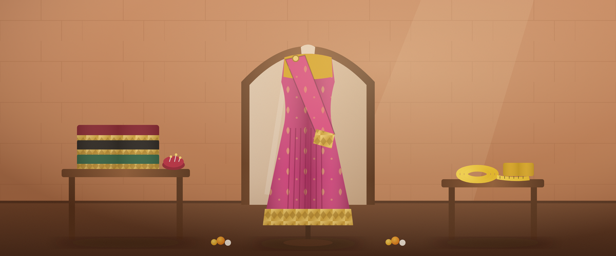 Pre-draped rani pink saree with stitched pleats on a dress form, with folded sarees, pins and a measuring tape