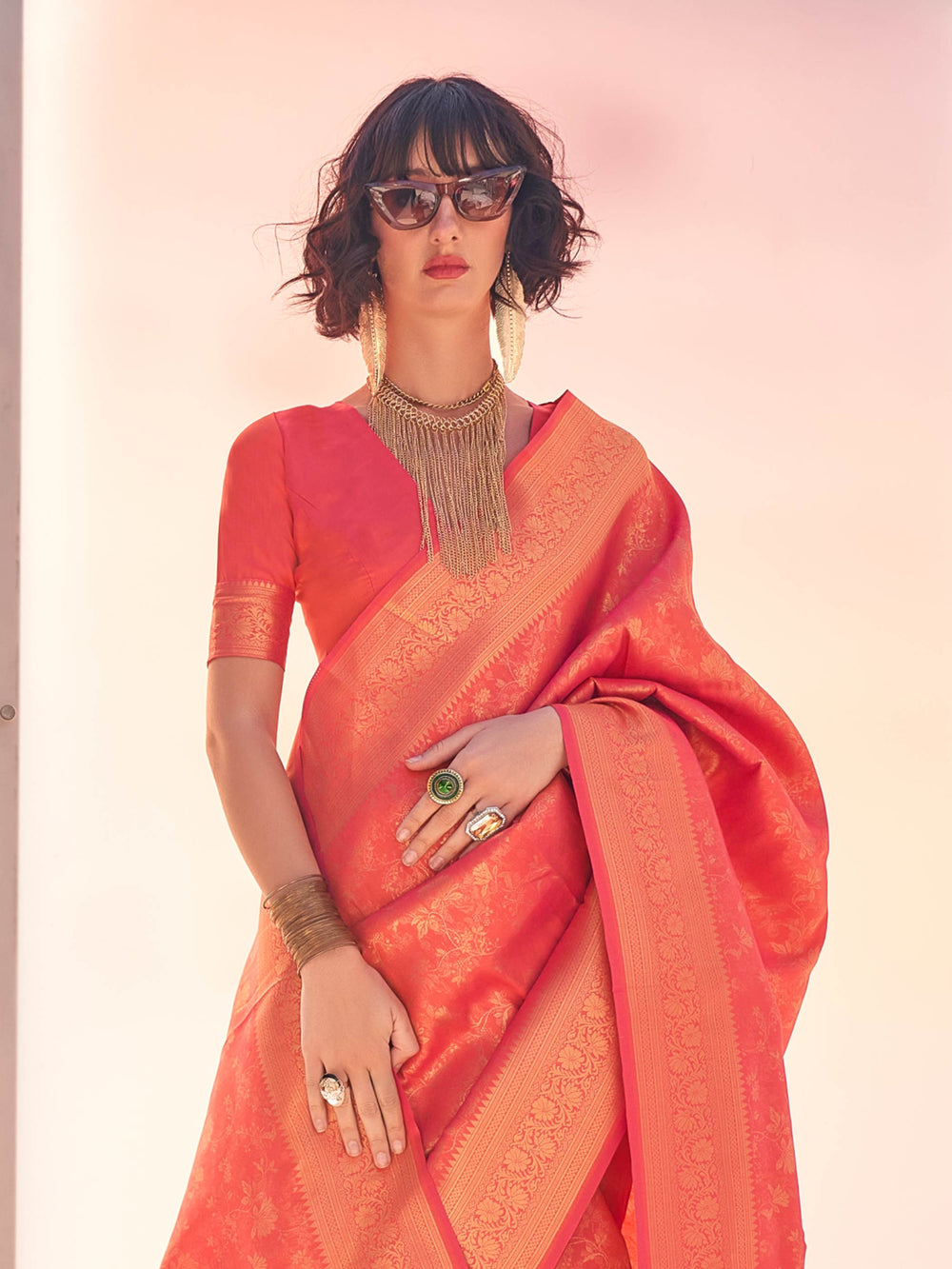Floral zari woven Coral–Gold drape with jacquard detailing and soft ethnic styling. Traditional Coral–Gold saree with kanjivaram weave and shimmering border motifs.