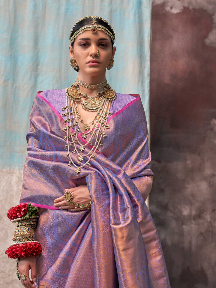 Lilac and Rose Gold two-tone handwoven silk saree with contrast selvage border and paisley weaving. This image captures the model styling perspective with complete saree ensemble displayed, ideal for visualizing festive elegance, designer appeal, and modern styling inspiration. Perfect for online shoppers seeking detailed previews before purchase, enhancing saree visual merchandising and SEO-rich product display strategy.                                                                                       