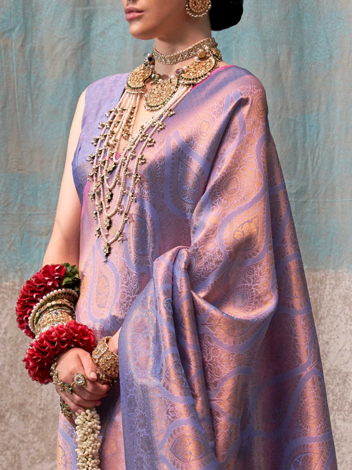 Lilac and Rose Gold two-tone handwoven silk saree with contrast selvage border and paisley weaving. This image captures the zoomed texture view illustrating fabric weave and print clarity, ideal for visualizing festive elegance, designer appeal, and modern styling inspiration. Perfect for online shoppers seeking detailed previews before purchase, enhancing saree visual merchandising and SEO-rich product display strategy.                                                                                        