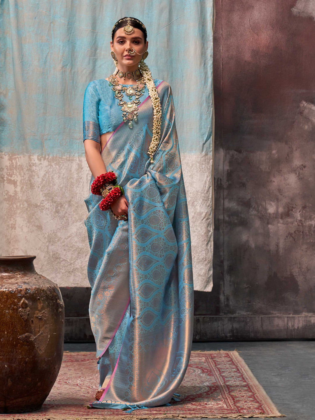 Blue and Peach two-tone handwoven silk saree with contrast selvage border and paisley weaving. This image captures the front drape view highlighting pallu fall and pleats alignment, ideal for visualizing festive elegance, designer appeal, and modern styling inspiration. Perfect for online shoppers seeking detailed previews before purchase, enhancing saree visual merchandising and SEO-rich product display strategy.                                                                                               