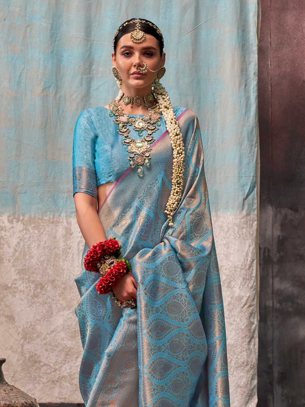 Blue and Peach two-tone handwoven silk saree with contrast selvage border and paisley weaving. This image captures the side angle view showcasing blouse styling and zari border detail, ideal for visualizing festive elegance, designer appeal, and modern styling inspiration. Perfect for online shoppers seeking detailed previews before purchase, enhancing saree visual merchandising and SEO-rich product display strategy.                                                                                            