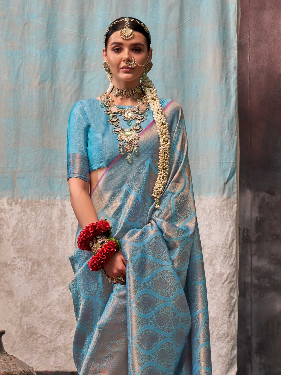 Blue and Peach two-tone handwoven silk saree with contrast selvage border and paisley weaving. This image captures the side angle view showcasing blouse styling and zari border detail, ideal for visualizing festive elegance, designer appeal, and modern styling inspiration. Perfect for online shoppers seeking detailed previews before purchase, enhancing saree visual merchandising and SEO-rich product display strategy.                                                                                            