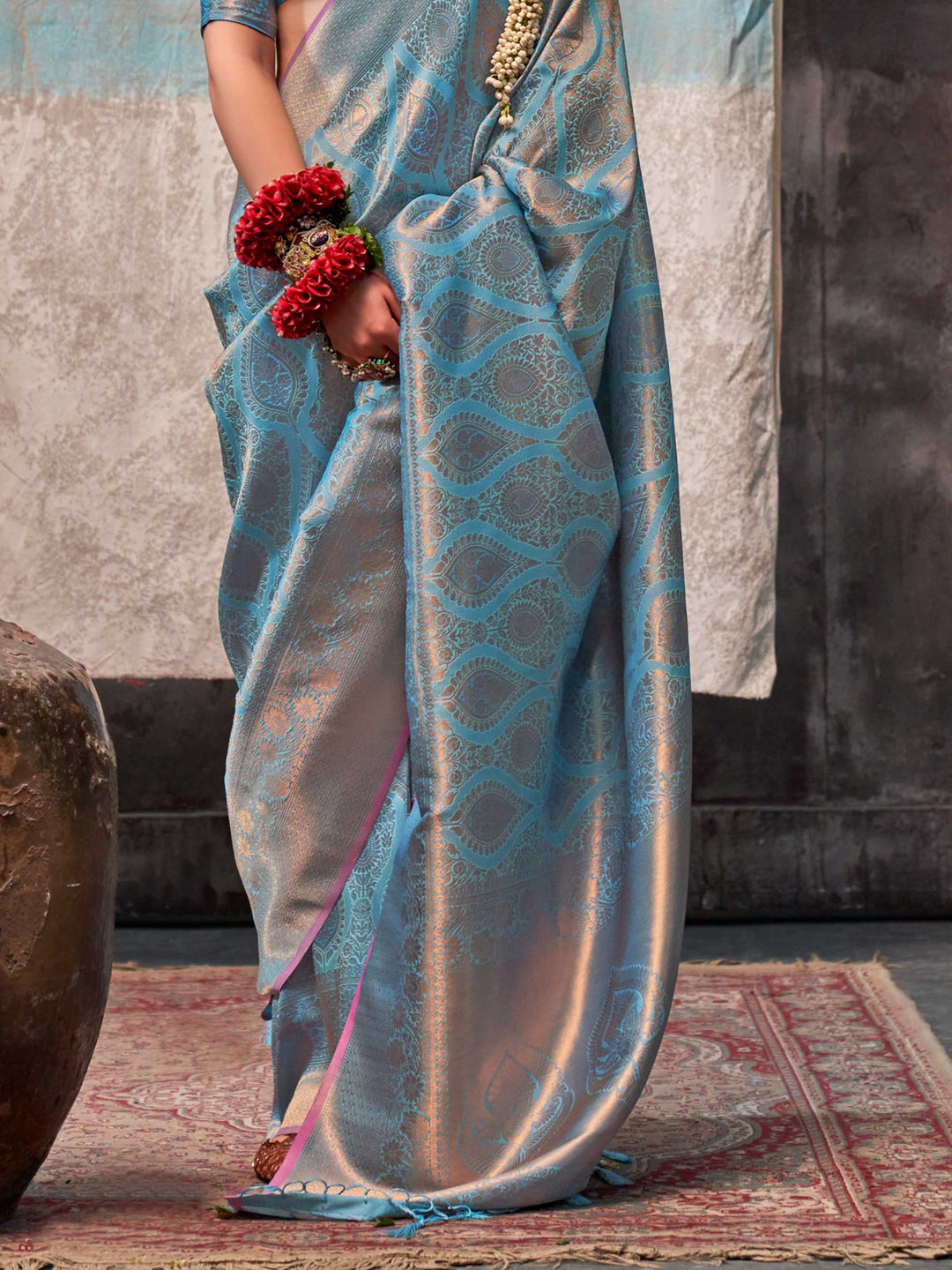 Blue and Peach two-tone handwoven silk saree with contrast selvage border and paisley weaving. This image captures the back drape focus revealing pallu finesse and motif richness, ideal for visualizing festive elegance, designer appeal, and modern styling inspiration. Perfect for online shoppers seeking detailed previews before purchase, enhancing saree visual merchandising and SEO-rich product display strategy.                                                                                                 
