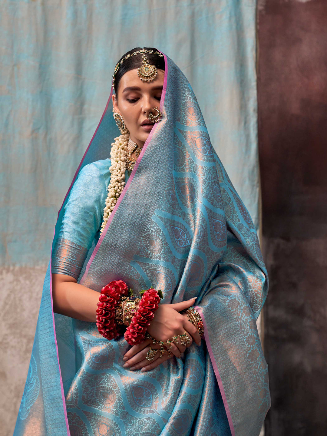 Blue and Peach two-tone handwoven silk saree with contrast selvage border and paisley weaving. This image captures the model styling perspective with complete saree ensemble displayed, ideal for visualizing festive elegance, designer appeal, and modern styling inspiration. Perfect for online shoppers seeking detailed previews before purchase, enhancing saree visual merchandising and SEO-rich product display strategy.                                                                                            