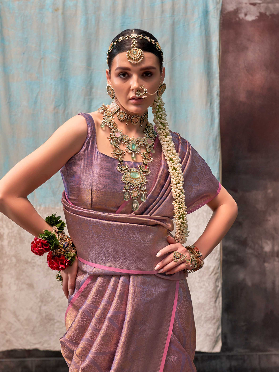 Lavender and Rose Gold two-tone handwoven silk saree with contrast selvage border and paisley weaving. This image captures the model styling perspective with complete saree ensemble displayed, ideal for visualizing festive elegance, designer appeal, and modern styling inspiration. Perfect for online shoppers seeking detailed previews before purchase, enhancing saree visual merchandising and SEO-rich product display strategy.                                                                                    