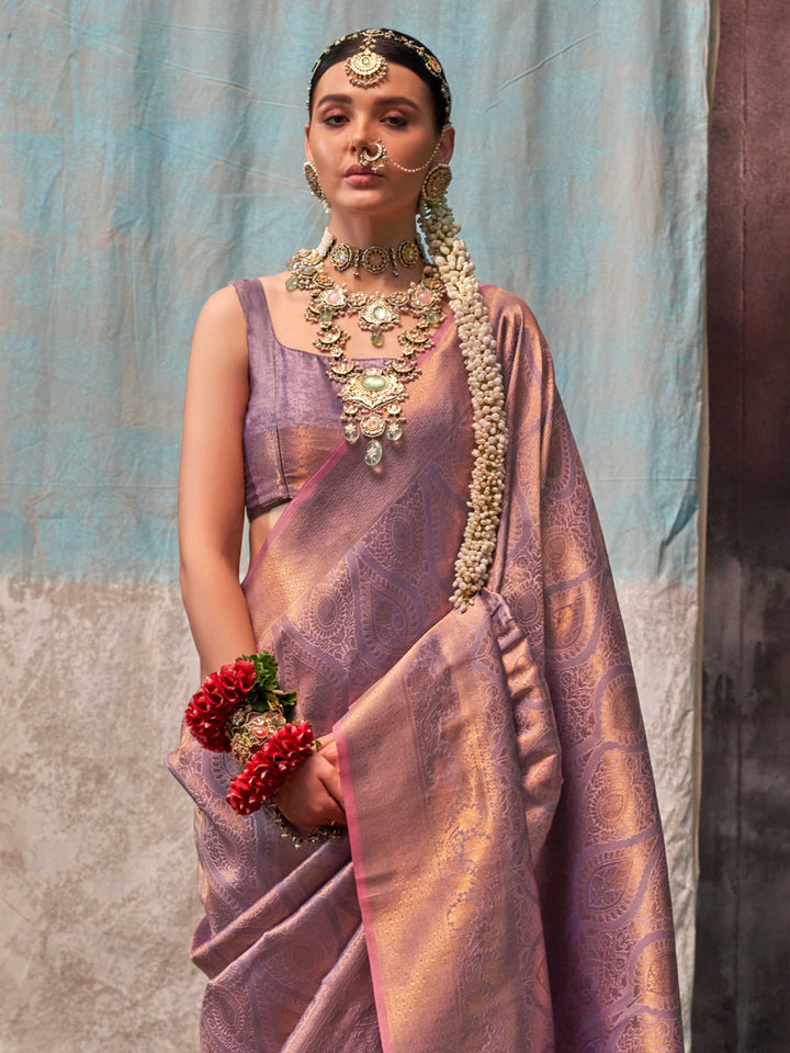 Lavender and Rose Gold two-tone handwoven silk saree with contrast selvage border and paisley weaving. This image captures the side angle view showcasing blouse styling and zari border detail, ideal for visualizing festive elegance, designer appeal, and modern styling inspiration. Perfect for online shoppers seeking detailed previews before purchase, enhancing saree visual merchandising and SEO-rich product display strategy.                                                                                    