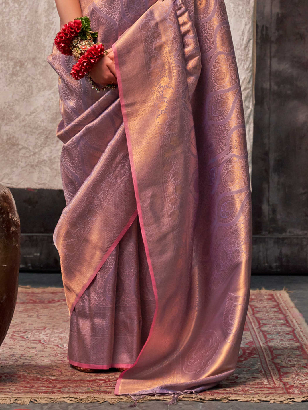 Lavender and Rose Gold two-tone handwoven silk saree with contrast selvage border and paisley weaving. This image captures the back drape focus revealing pallu finesse and motif richness, ideal for visualizing festive elegance, designer appeal, and modern styling inspiration. Perfect for online shoppers seeking detailed previews before purchase, enhancing saree visual merchandising and SEO-rich product display strategy.                                                                                         