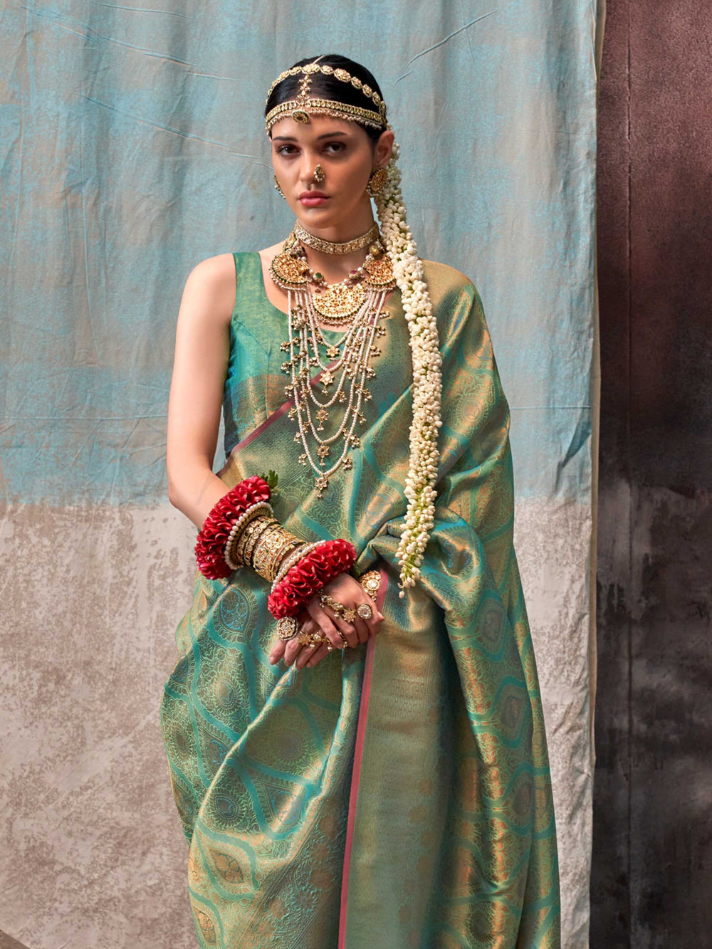 Green and Gold two-tone handwoven silk saree with contrast selvage border and paisley weaving. This image captures the side angle view showcasing blouse styling and zari border detail, ideal for visualizing festive elegance, designer appeal, and modern styling inspiration. Perfect for online shoppers seeking detailed previews before purchase, enhancing saree visual merchandising and SEO-rich product display strategy.                                                                                            