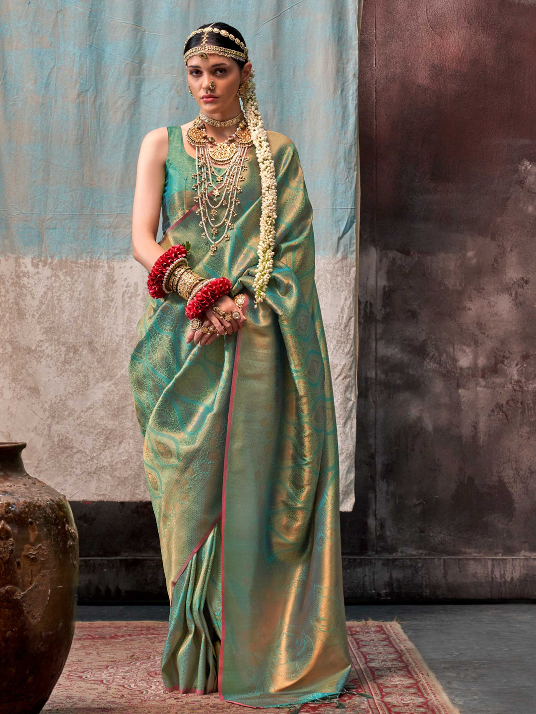 Green and Gold two-tone handwoven silk saree with contrast selvage border and paisley weaving. This image captures the front drape view highlighting pallu fall and pleats alignment, ideal for visualizing festive elegance, designer appeal, and modern styling inspiration. Perfect for online shoppers seeking detailed previews before purchase, enhancing saree visual merchandising and SEO-rich product display strategy.                                                                                               