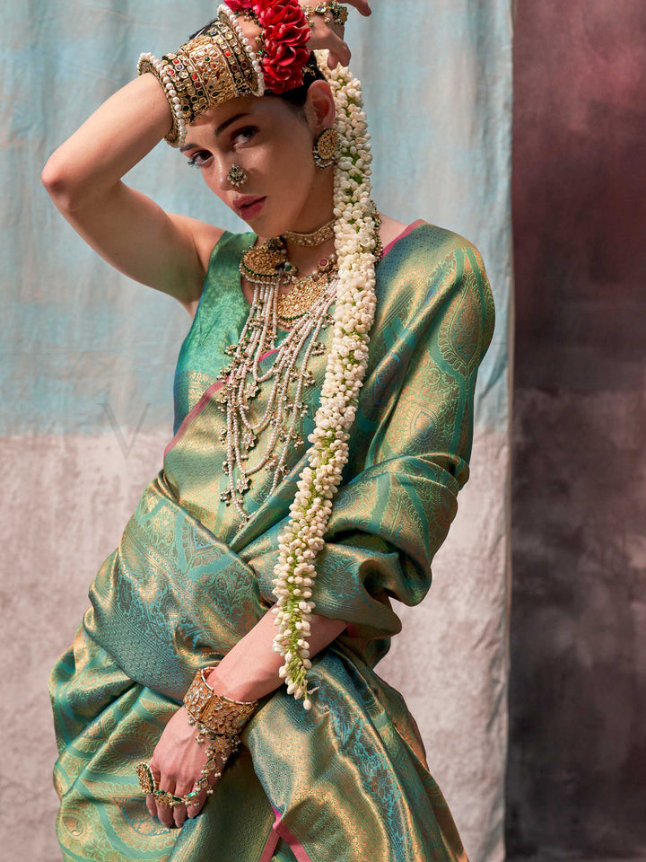 Green and Gold two-tone handwoven silk saree with contrast selvage border and paisley weaving. This image captures the pallu detail angle emphasizing zari accents and design composition, ideal for visualizing festive elegance, designer appeal, and modern styling inspiration. Perfect for online shoppers seeking detailed previews before purchase, enhancing saree visual merchandising and SEO-rich product display strategy.                                                                                          
