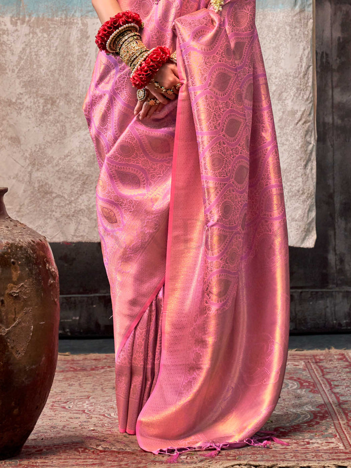Pink and Rose Gold two-tone handwoven silk saree with contrast selvage border and paisley weaving. This image captures the back drape focus revealing pallu finesse and motif richness, ideal for visualizing festive elegance, designer appeal, and modern styling inspiration. Perfect for online shoppers seeking detailed previews before purchase, enhancing saree visual merchandising and SEO-rich product display strategy.                                                                                             