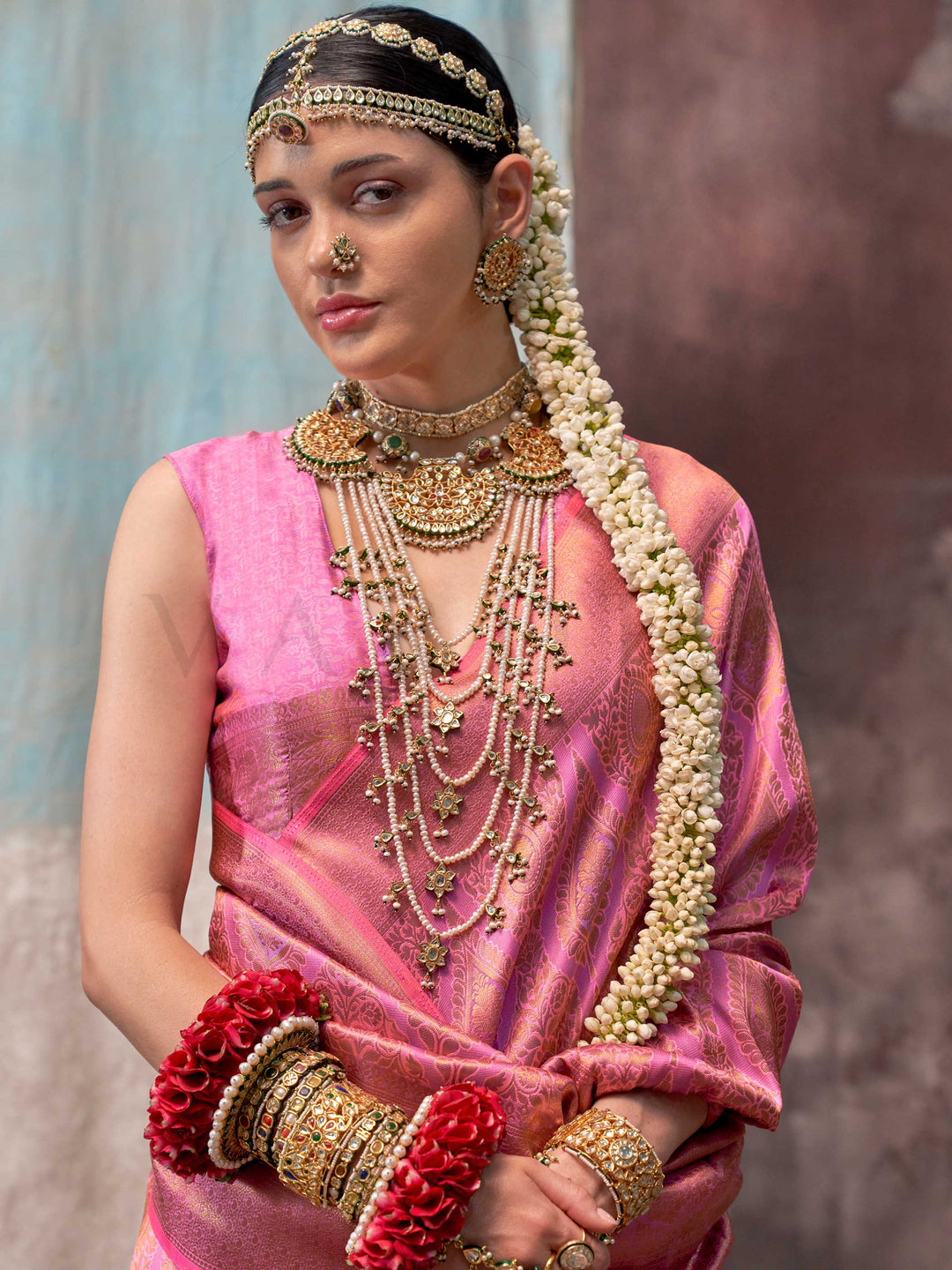 Pink and Rose Gold two-tone handwoven silk saree with contrast selvage border and paisley weaving. This image captures the model styling perspective with complete saree ensemble displayed, ideal for visualizing festive elegance, designer appeal, and modern styling inspiration. Perfect for online shoppers seeking detailed previews before purchase, enhancing saree visual merchandising and SEO-rich product display strategy.                                                                                        