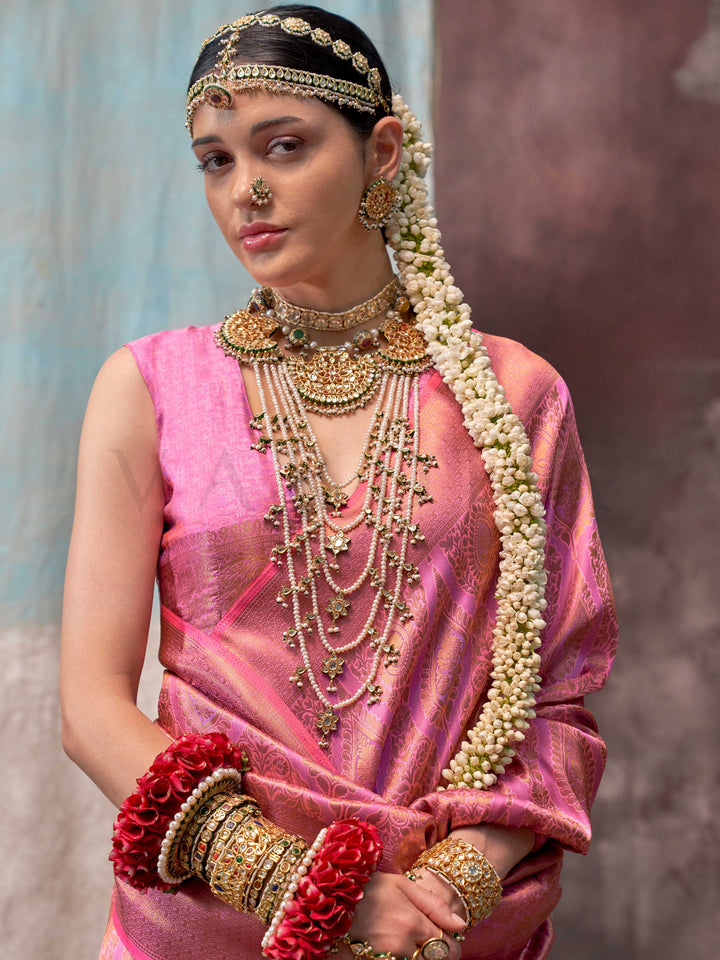 Pink and Rose Gold two-tone handwoven silk saree with contrast selvage border and paisley weaving. This image captures the model styling perspective with complete saree ensemble displayed, ideal for visualizing festive elegance, designer appeal, and modern styling inspiration. Perfect for online shoppers seeking detailed previews before purchase, enhancing saree visual merchandising and SEO-rich product display strategy.                                                                                        