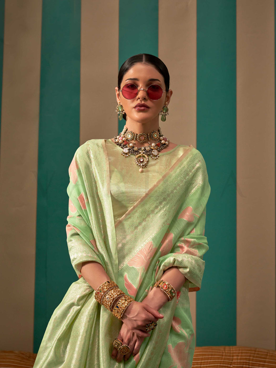 Mint Green and Peach linen saree with floral woven motifs and soft handloom texture This image captures the model styling perspective with complete saree ensemble displayed, ideal for visualizing festive elegance, designer appeal, and modern styling inspiration. Perfect for online shoppers seeking detailed previews before purchase, enhancing saree visual merchandising and SEO-rich product display strategy.                                                                                                       
