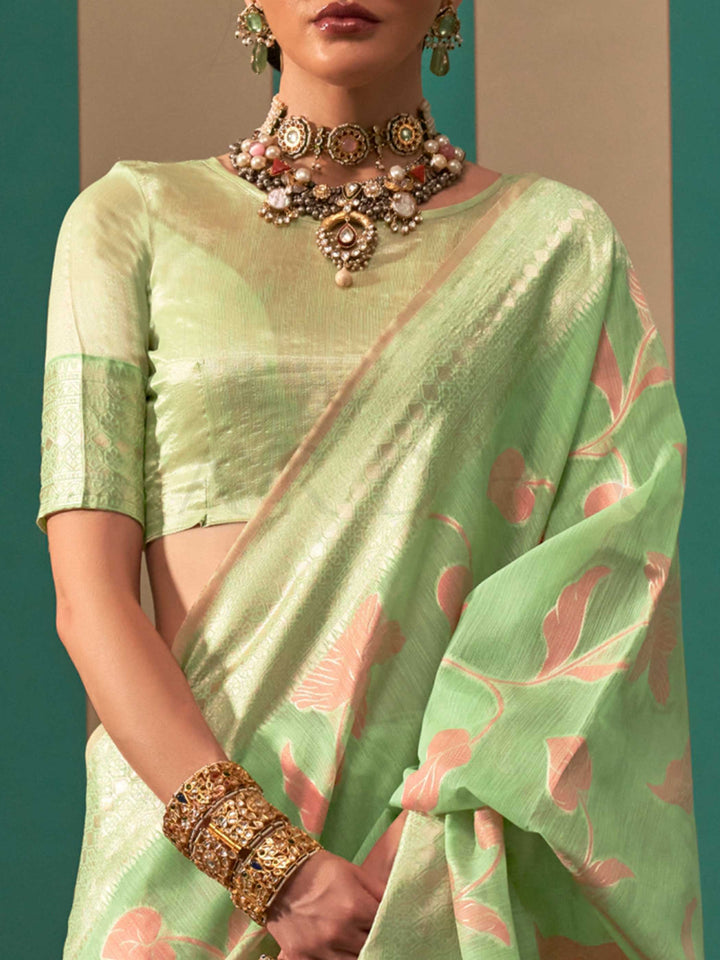 Mint Green and Peach linen saree with floral woven motifs and soft handloom texture This image captures the zoomed texture view illustrating fabric weave and print clarity, ideal for visualizing festive elegance, designer appeal, and modern styling inspiration. Perfect for online shoppers seeking detailed previews before purchase, enhancing saree visual merchandising and SEO-rich product display strategy.                                                                                                        