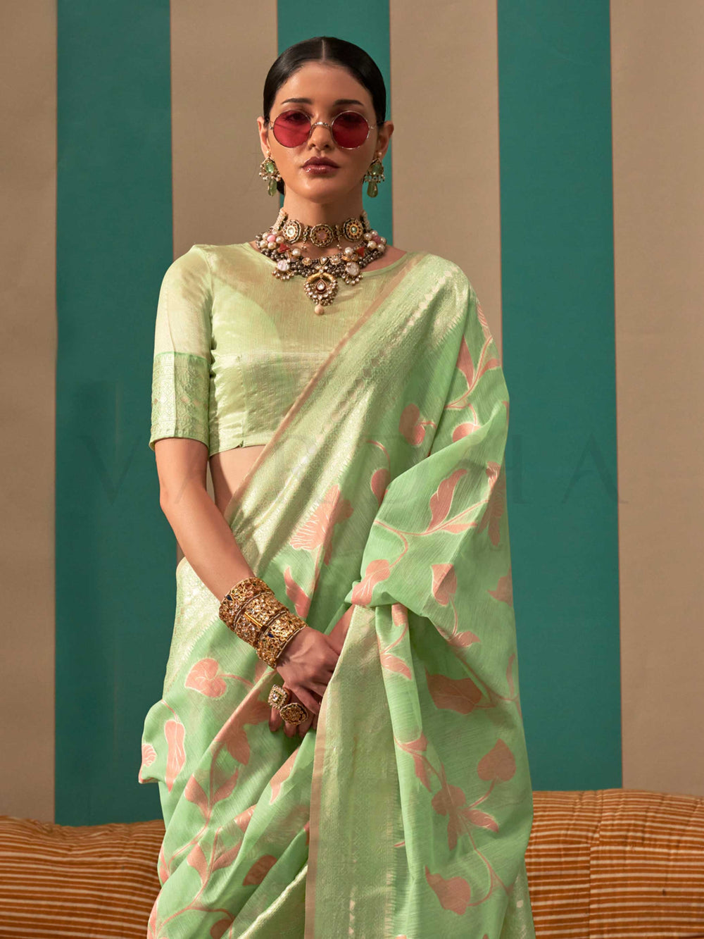 Mint Green and Peach linen saree with floral woven motifs and soft handloom texture This image captures the side angle view showcasing blouse styling and zari border detail, ideal for visualizing festive elegance, designer appeal, and modern styling inspiration. Perfect for online shoppers seeking detailed previews before purchase, enhancing saree visual merchandising and SEO-rich product display strategy.                                                                                                       