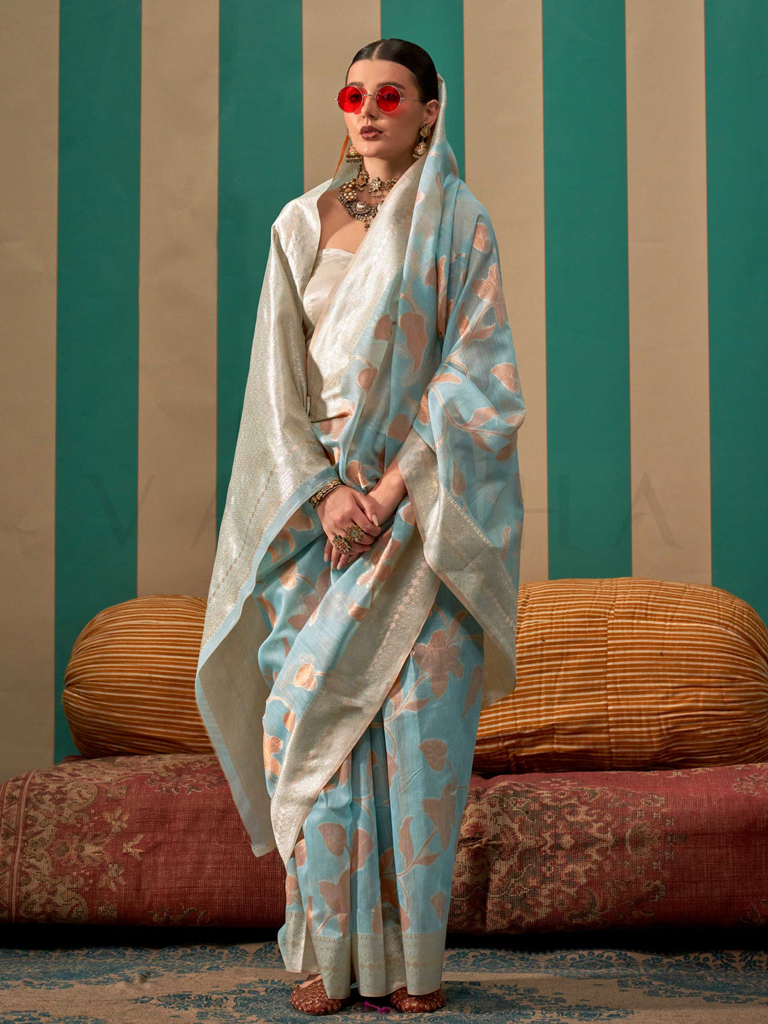 Sky Blue and Pearl White linen saree with floral woven motifs and soft handloom texture This image captures the model styling perspective with complete saree ensemble displayed, ideal for visualizing festive elegance, designer appeal, and modern styling inspiration. Perfect for online shoppers seeking detailed previews before purchase, enhancing saree visual merchandising and SEO-rich product display strategy.                                                                                                   