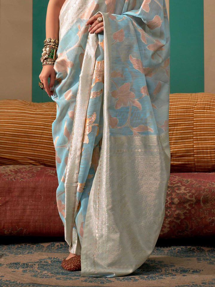 Sky Blue and Pearl White linen saree with floral woven motifs and soft handloom texture This image captures the back drape focus revealing pallu finesse and motif richness, ideal for visualizing festive elegance, designer appeal, and modern styling inspiration. Perfect for online shoppers seeking detailed previews before purchase, enhancing saree visual merchandising and SEO-rich product display strategy.                                                                                                        