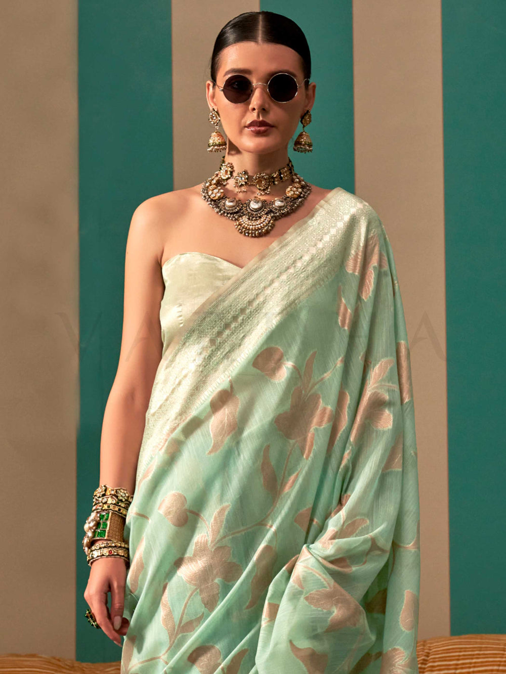 Aqua Green and Cream linen saree with floral woven motifs and soft handloom texture This image captures the side angle view showcasing blouse styling and zari border detail, ideal for visualizing festive elegance, designer appeal, and modern styling inspiration. Perfect for online shoppers seeking detailed previews before purchase, enhancing saree visual merchandising and SEO-rich product display strategy.                                                                                                       
