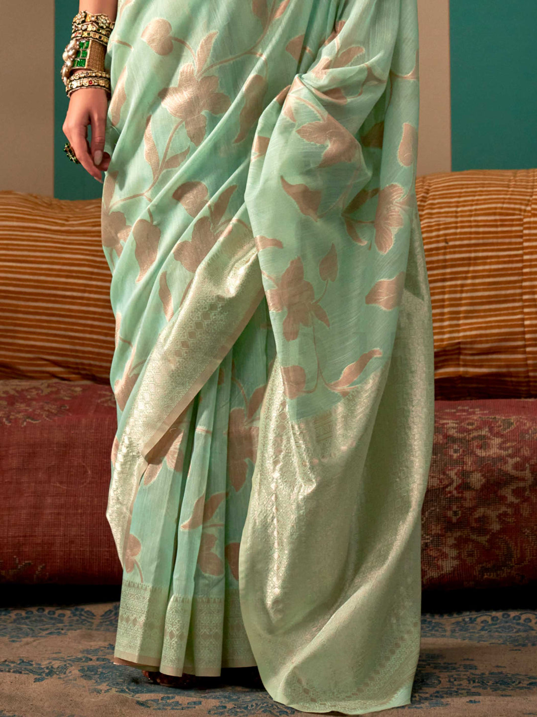 Aqua Green and Cream linen saree with floral woven motifs and soft handloom texture This image captures the back drape focus revealing pallu finesse and motif richness, ideal for visualizing festive elegance, designer appeal, and modern styling inspiration. Perfect for online shoppers seeking detailed previews before purchase, enhancing saree visual merchandising and SEO-rich product display strategy.                                                                                                            